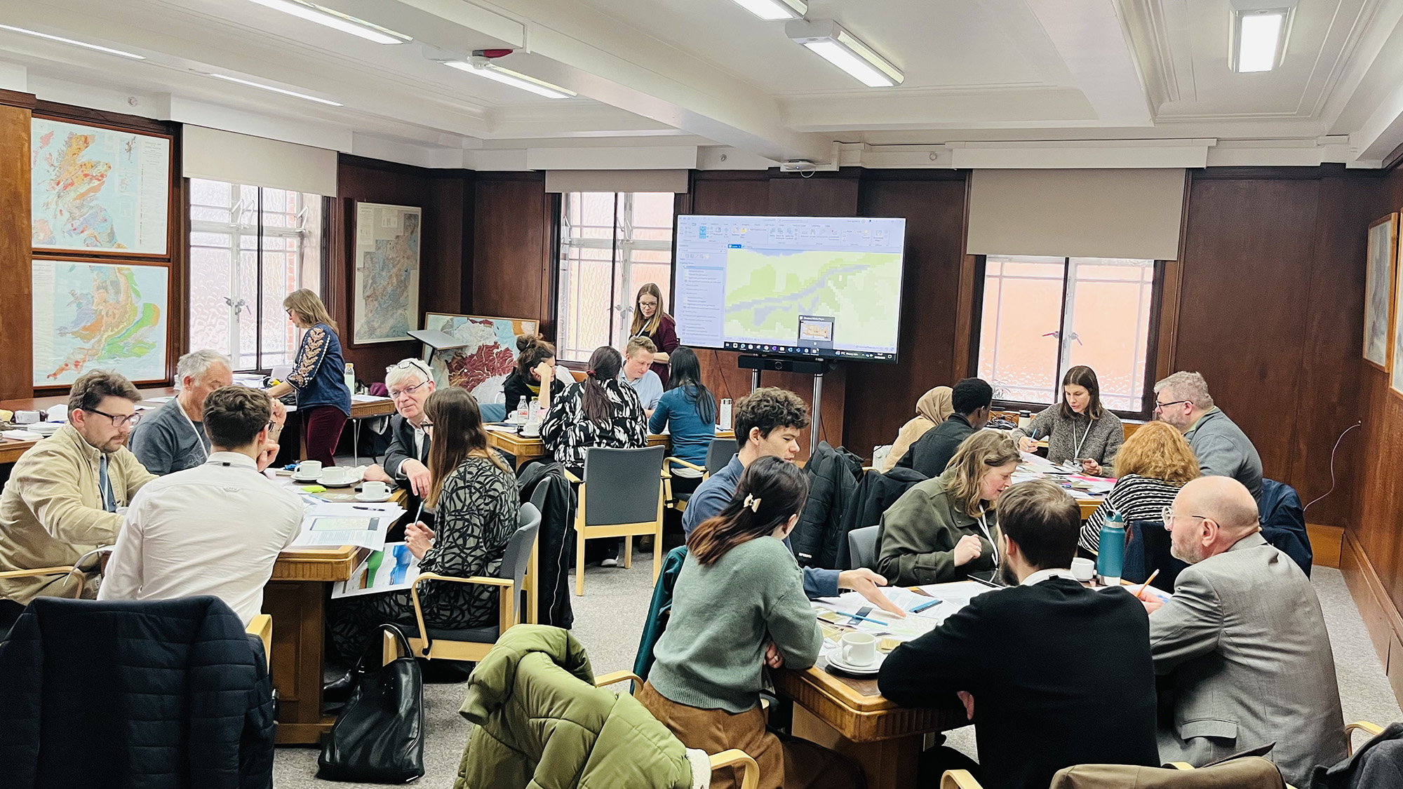People grouped around tables in a educational setting