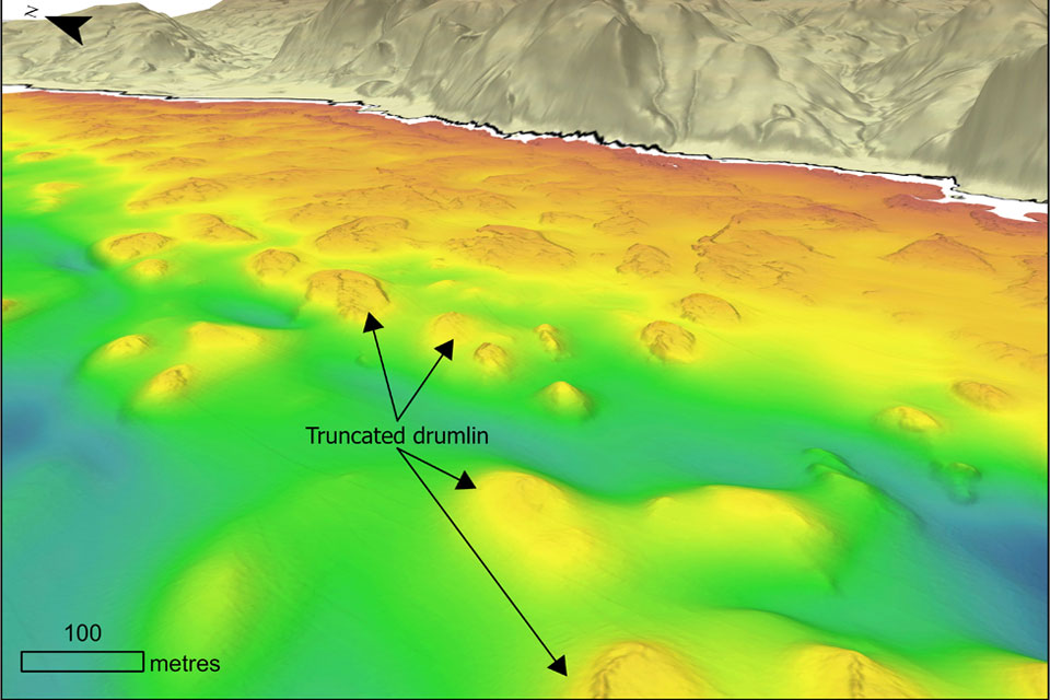 Truncated drumlins offshore the Ayrshire coast, approximately between Girvan and Lendalfoot. The MBES bathymetry data in this figure were collected for the UK's Civil Hydrography Programme (CHP), managed by the Maritime & Coastguard Agency's (MCA) and delivered in partnership with the UK Hydrographic Office (UKHO). The onshore DEM is NEXTMap Britain elevation data provided courtesy of Intermap Technologies..